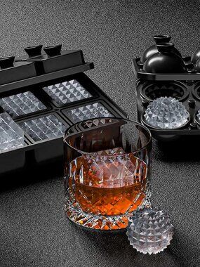 Guy sitting at a table full of different burgers and fries, laughing with a care